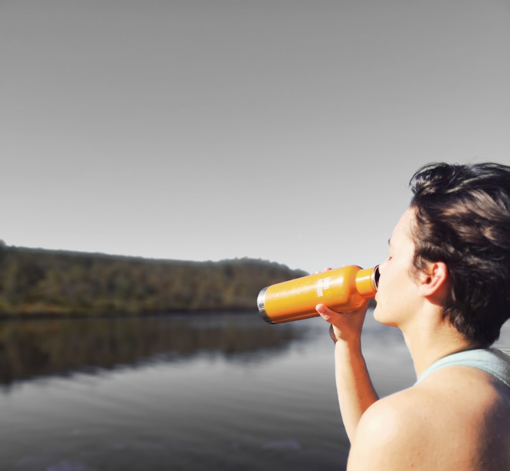 man drinking from a tumbler