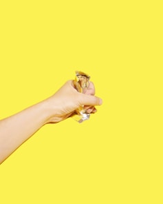 A warm, inviting portrait of a smiling team member holding a freshly made Snickers bar.