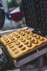 Close-up of a golden artisanal waffle fresh out of the iron