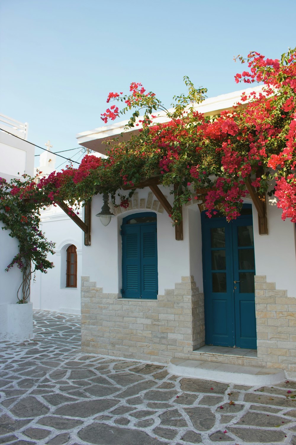 house with awning and flowers during day
