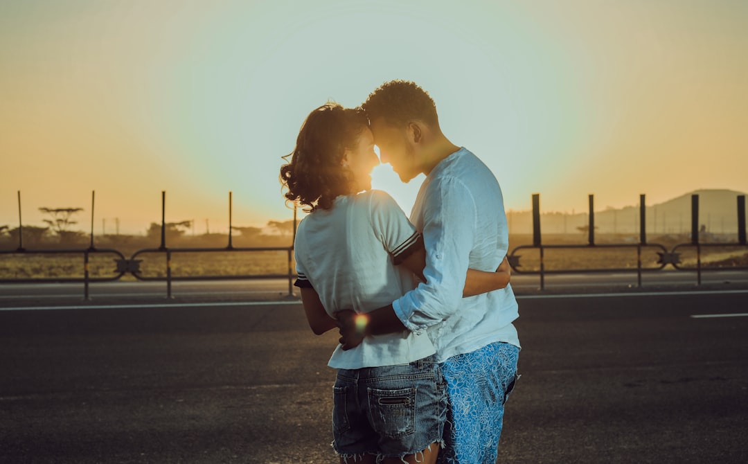 photo-shoot of couple stand on the road during golden hour