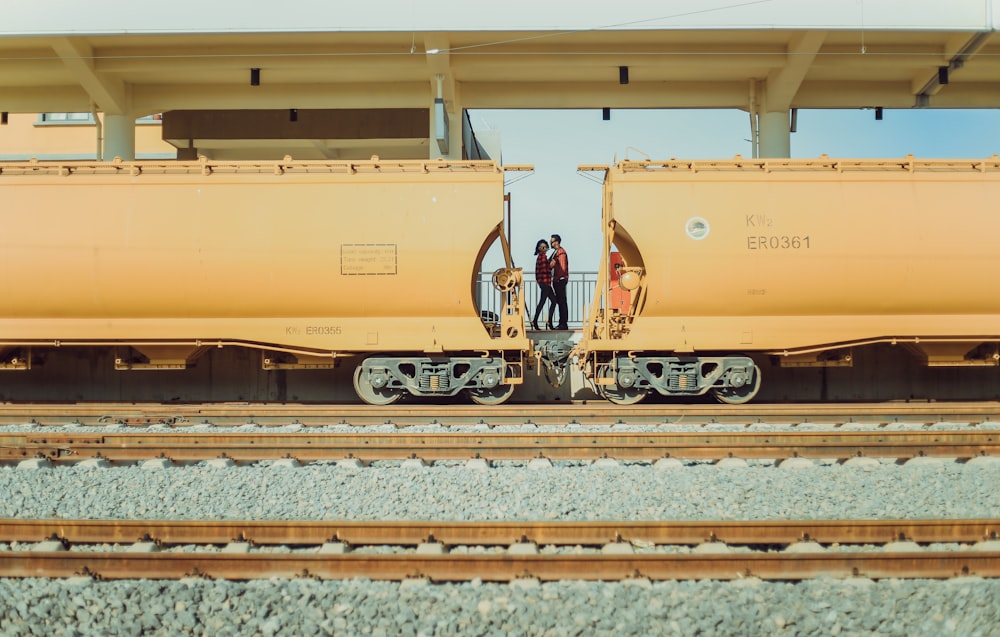 man and woman kissing in train station