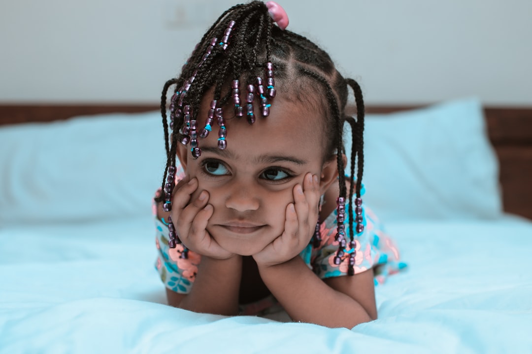 girl with braided hair on bed