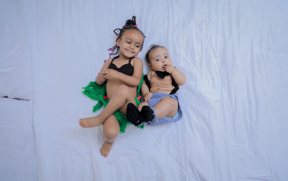 baby and girl on bed