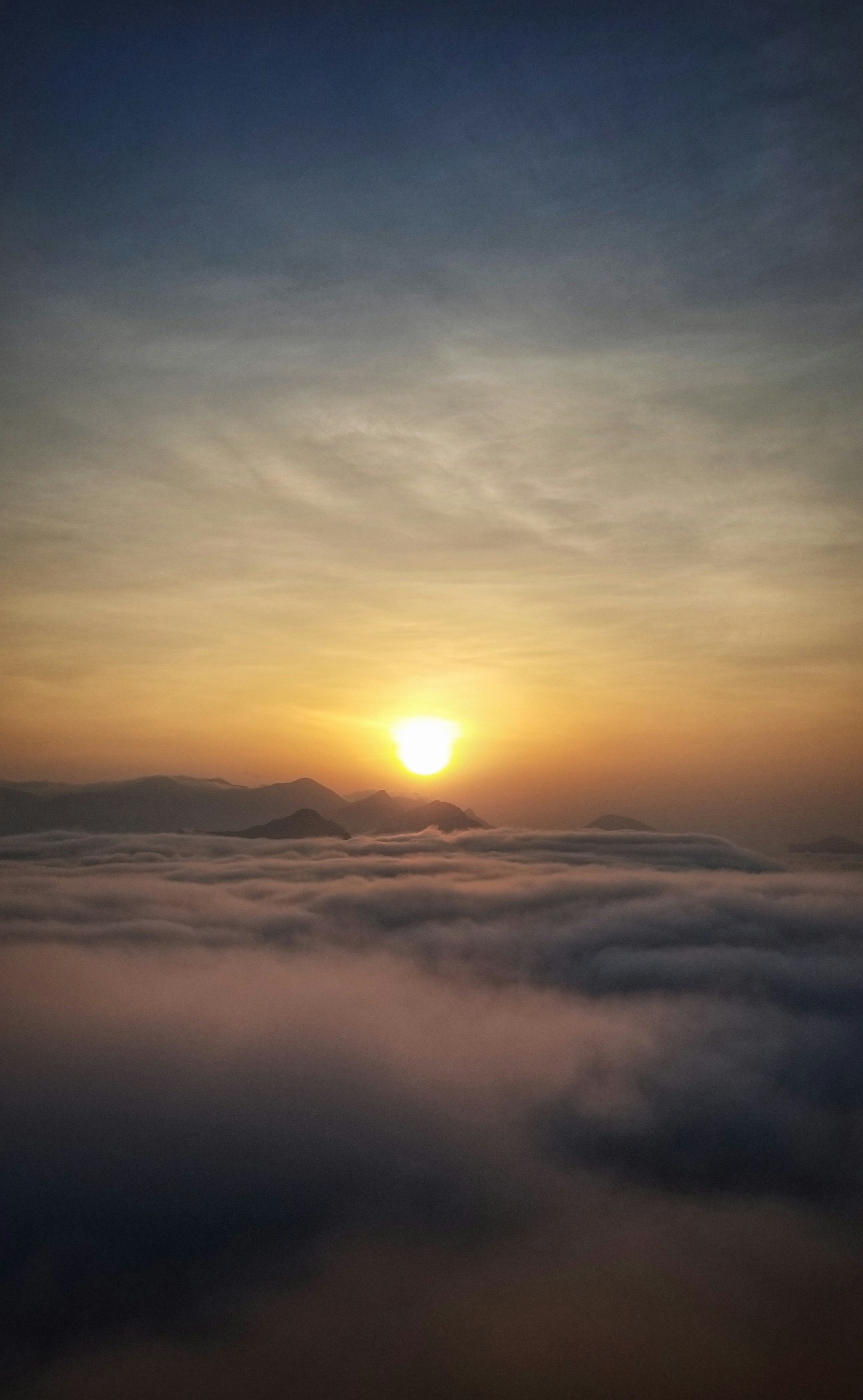 An uplifting scene of a sunrise over a mountain range, casting warm light and inspiring hope for a new day.