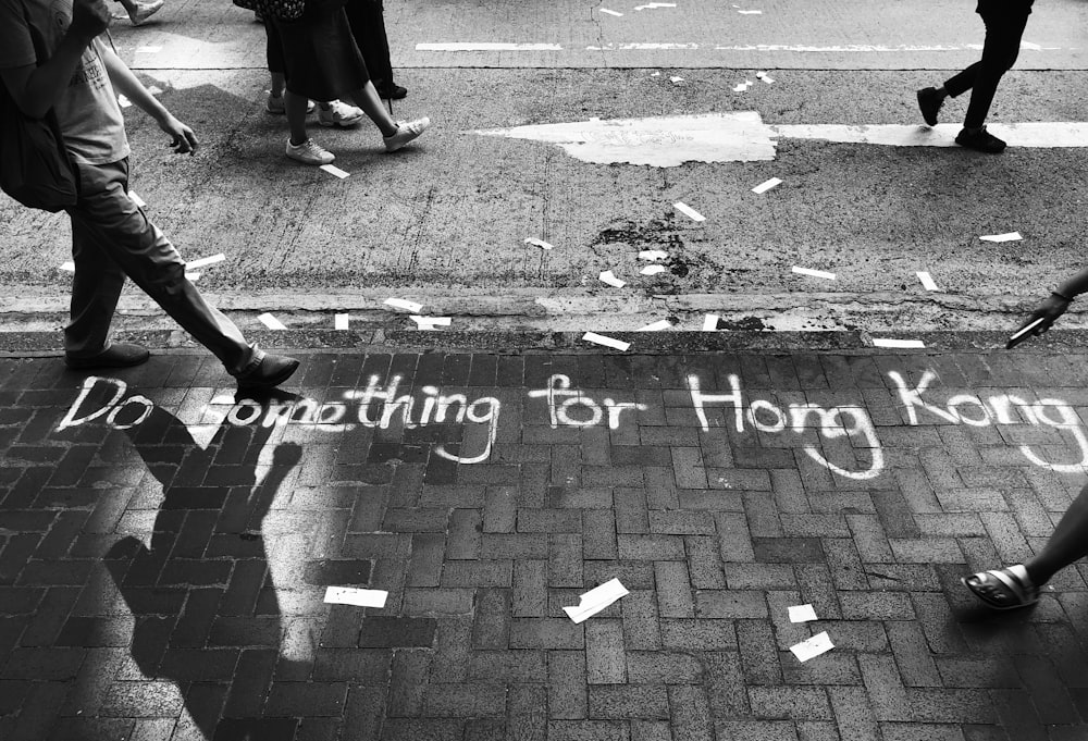 grayscale photography of do something for Hong Kong road text