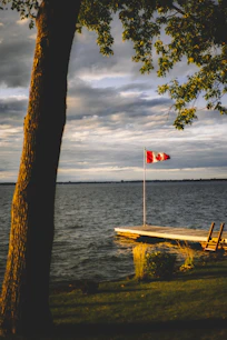 Canada flag raised on gray dock during daytime