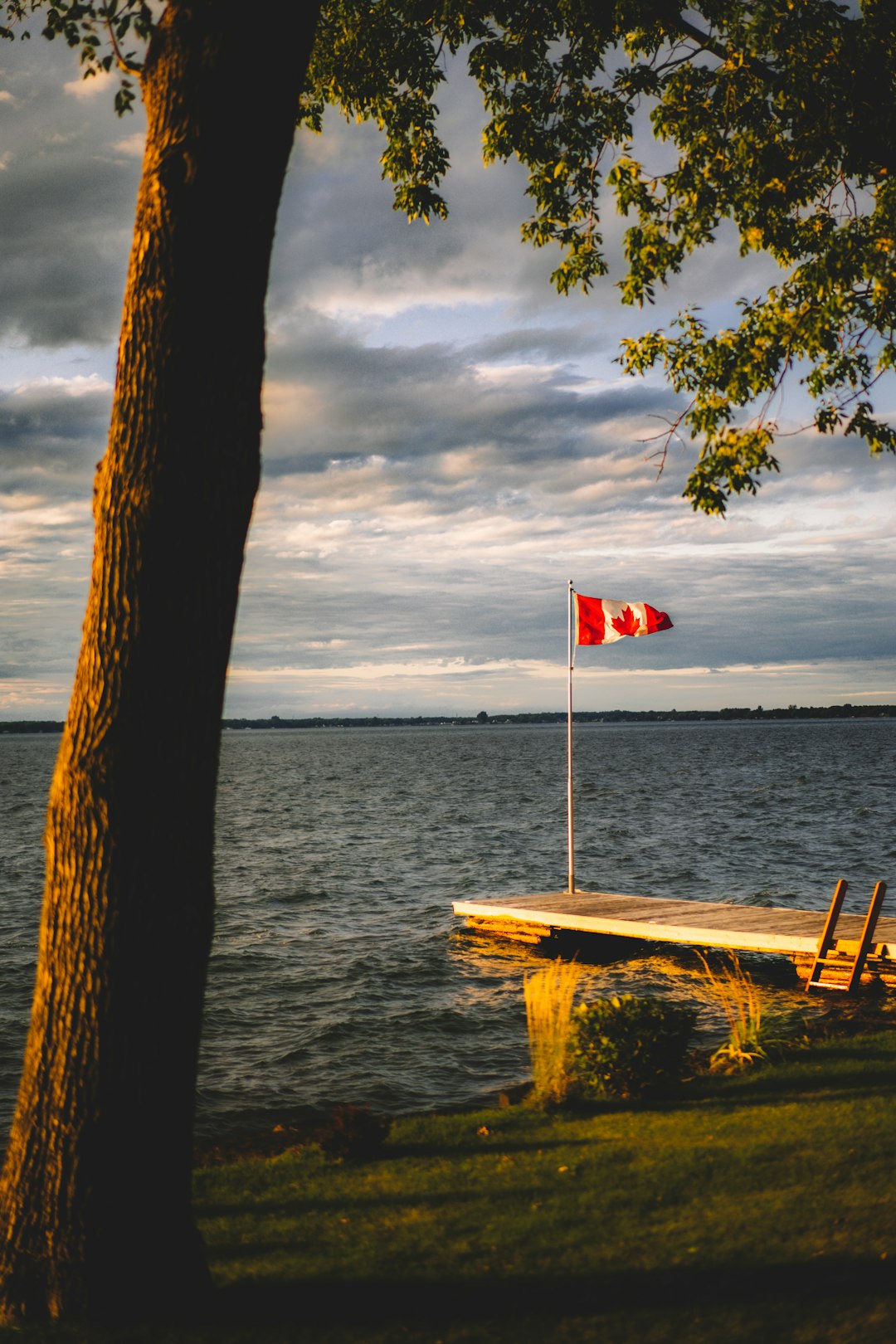 Canada flag raised on gray dock during daytime