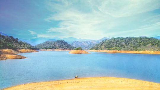 blue body of water surrounded by mountains in Udadumbara Sri Lanka
