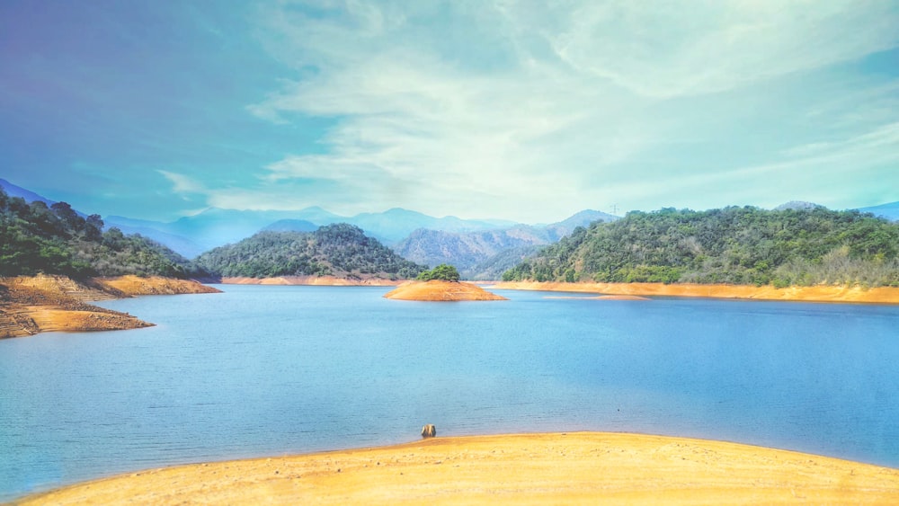 blue body of water surrounded by mountains