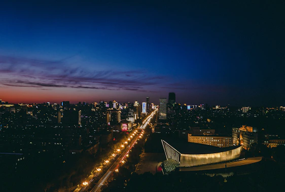 A student standing at the start of a illuminated career roadmap under a city skyline glowing at dusk.