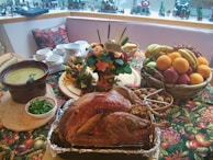 roasted chicken beside basket of fruits