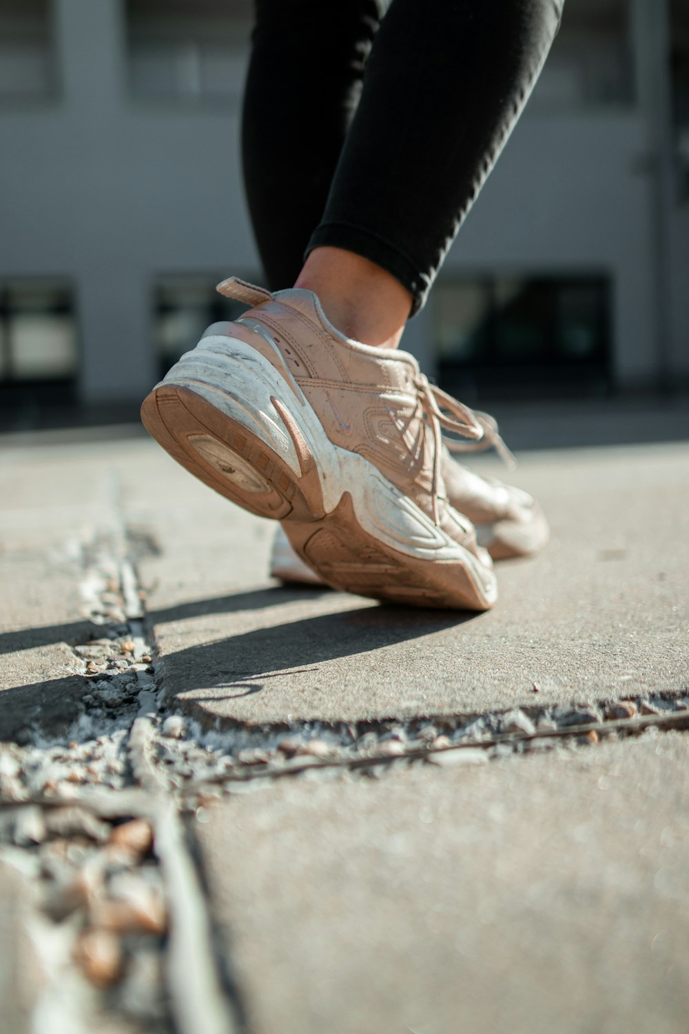 person wearing white-and-beige running shoes