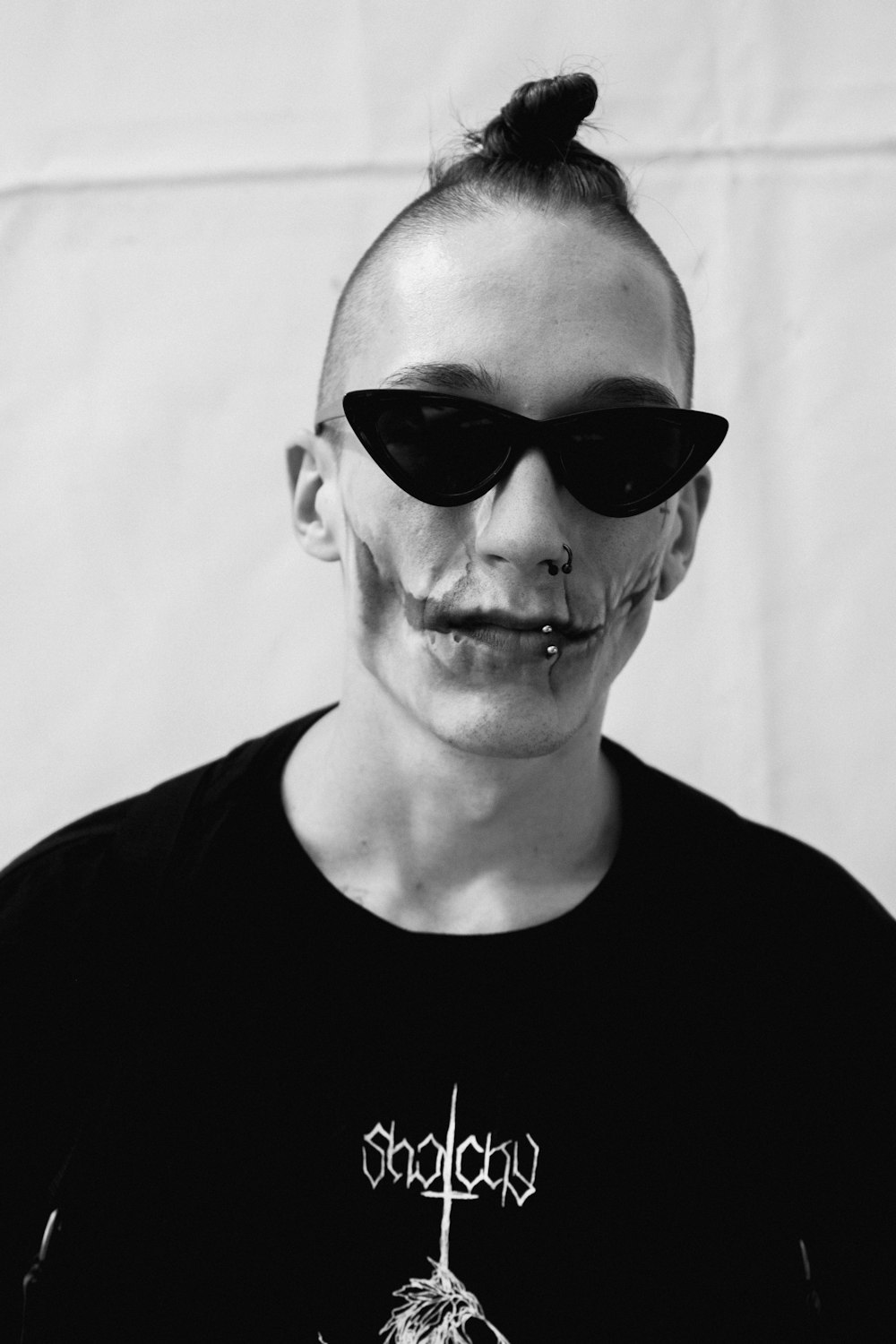 grayscale portrait photography of man wearing sunglasses