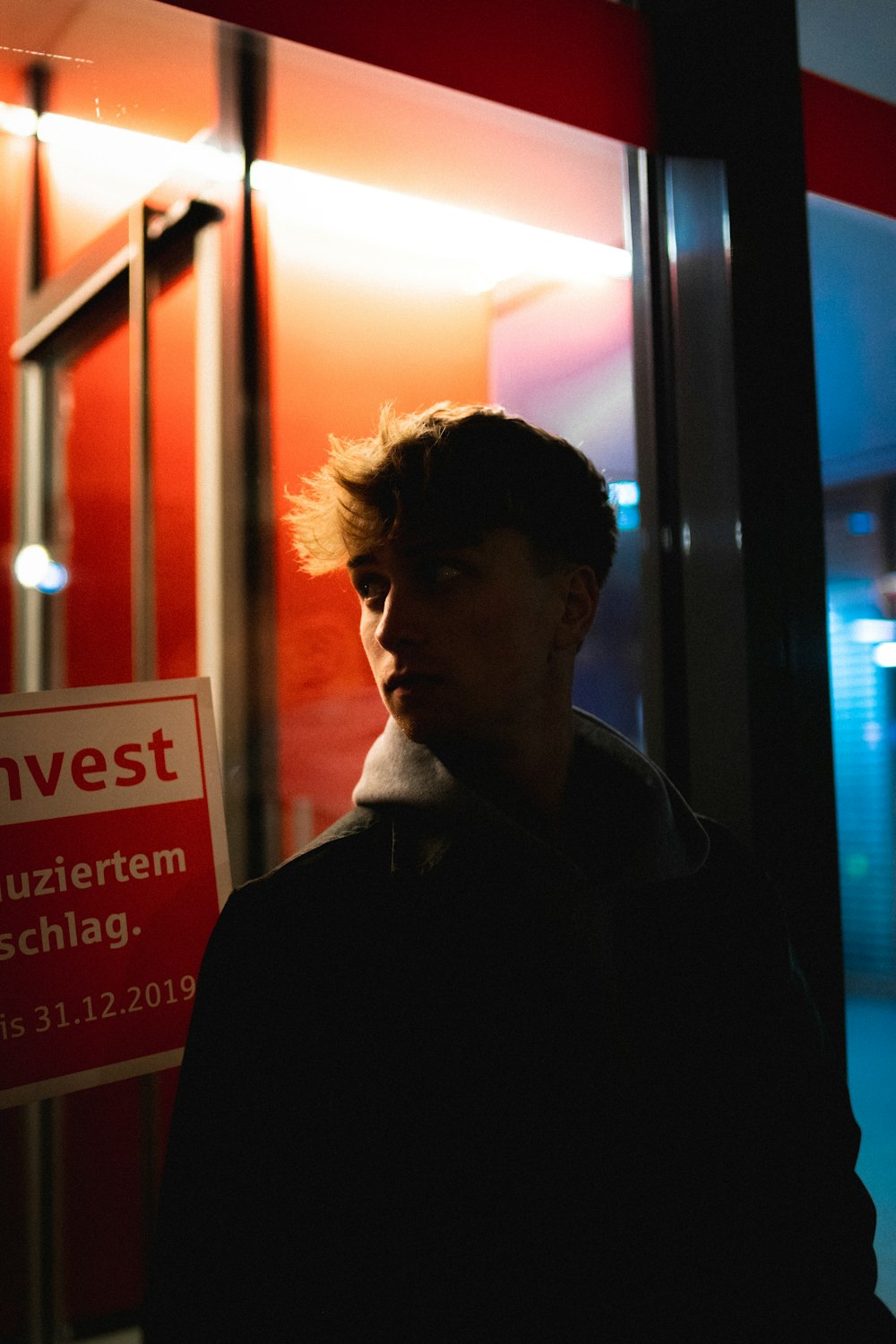 man leaning on clear wall