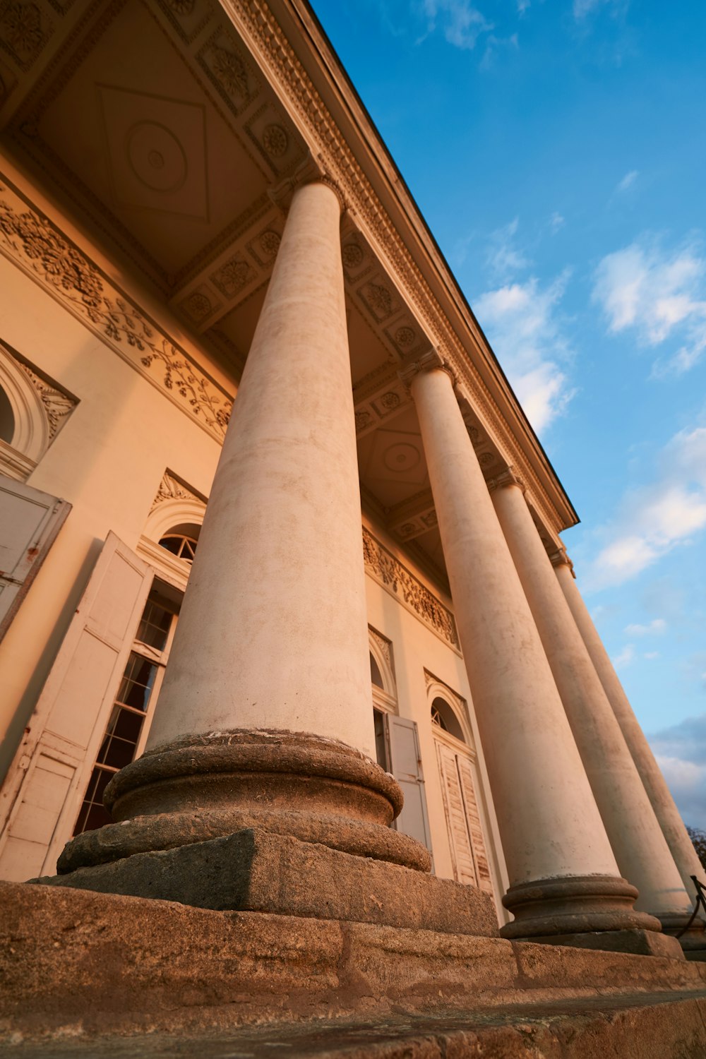 low-angle photography of Roman Temple under blue and white sky during daytime