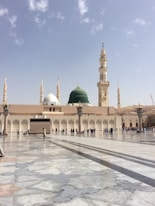 people walking outside a dome mosque building