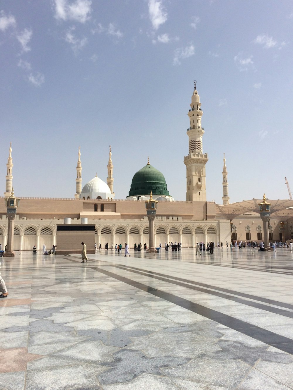 people walking outside a dome mosque building