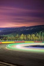 Futuristic racing track with glowing orange accents and sleek digital interface elements.
