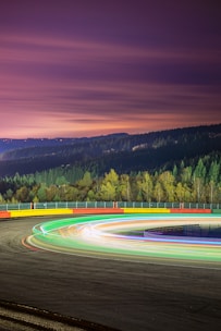 Futuristic racing track with glowing orange accents and sleek digital interface elements.