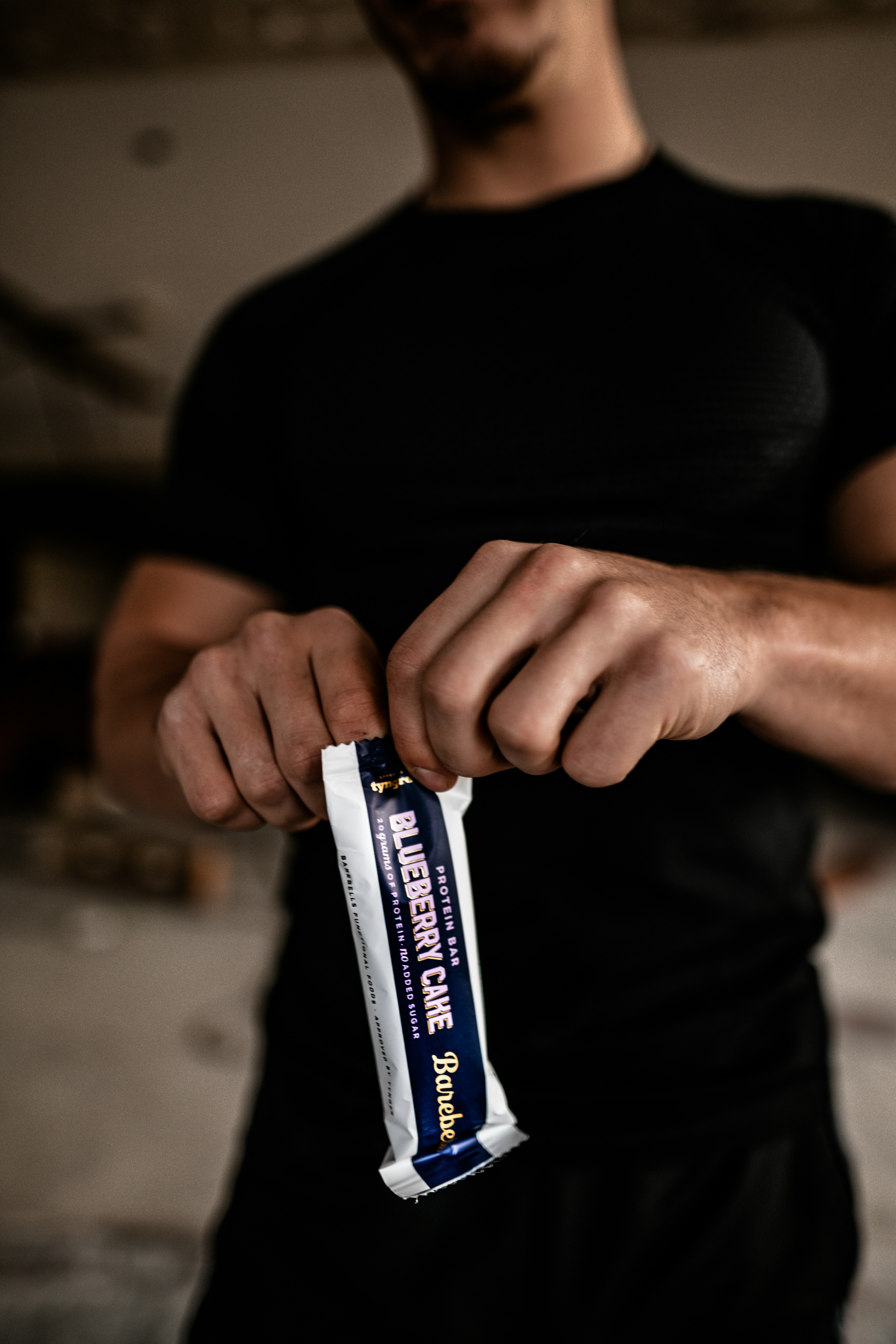 Runner tearing open an energy gel sachet