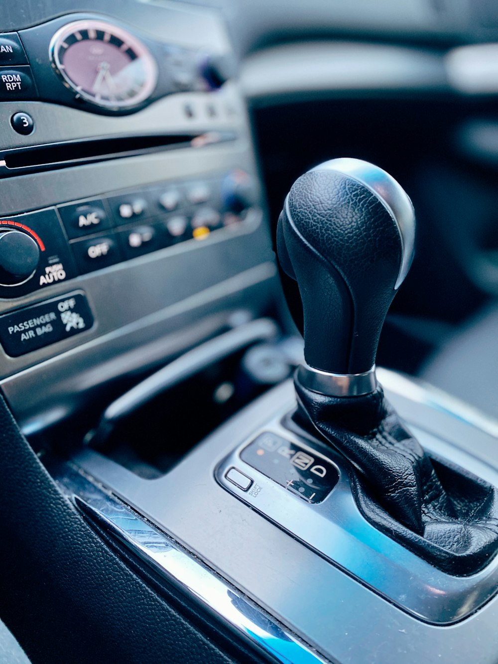 black and silver car gear shift lever