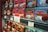 Rows of colorful vintage-style tin boxes are displayed on shelves, each containing La Mere Poulard butter cookies. The packaging features intricate designs and illustrations, emphasizing a traditional and artisanal product. Prominent signage with pricing and promotional offers is visible, indicating a special sale.