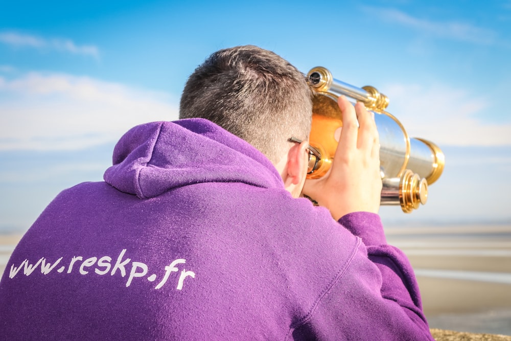 man wearing purple hooded jacket