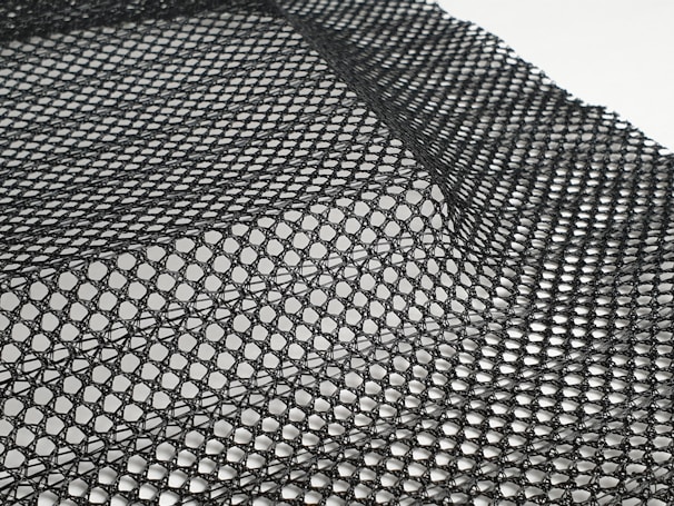 Various mesh samples showing different weave patterns and thicknesses laid out on a table.
