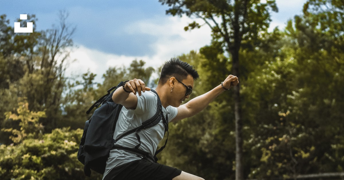 Man hop on the body of water through grass photo – Free Person Image on ...