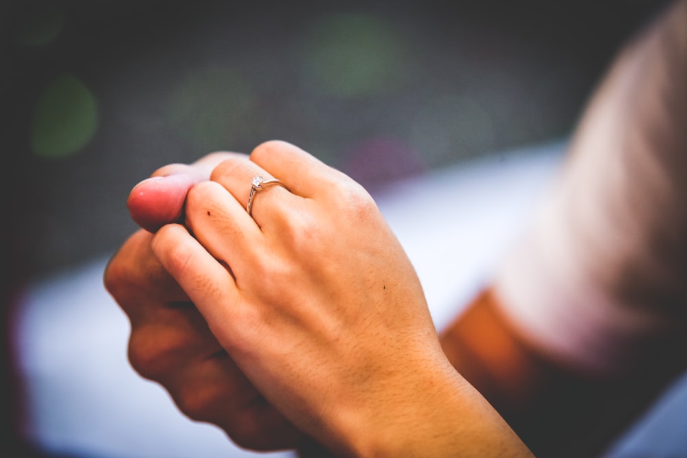 person wearing gold-colored ring