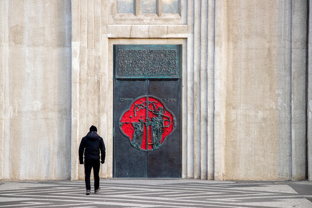 man walking towards closed French doors