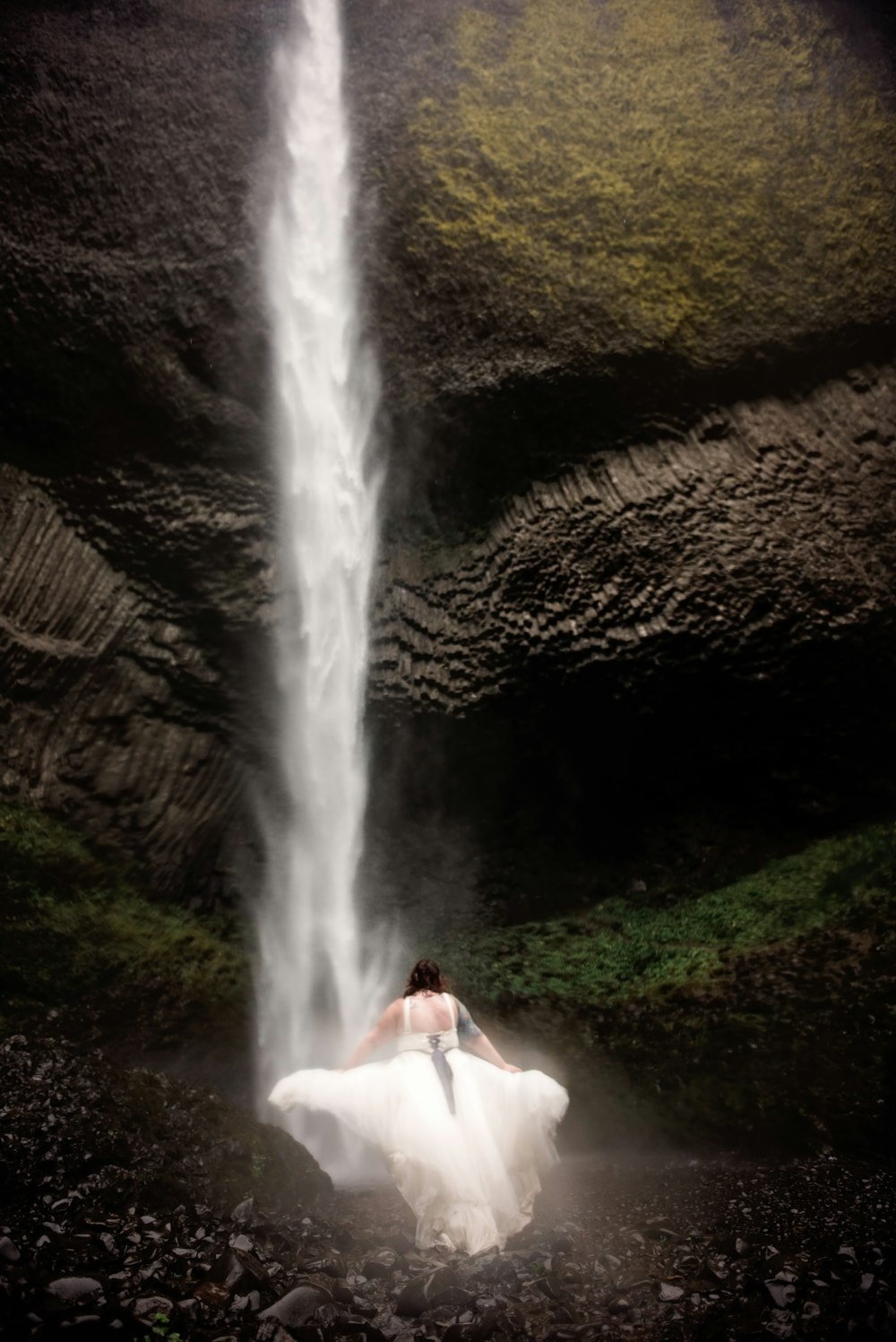woman standing in front of waterfalls