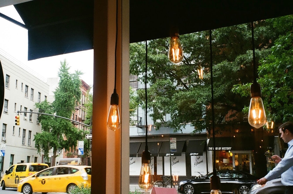 five lighted black and brown pendant light bulbs