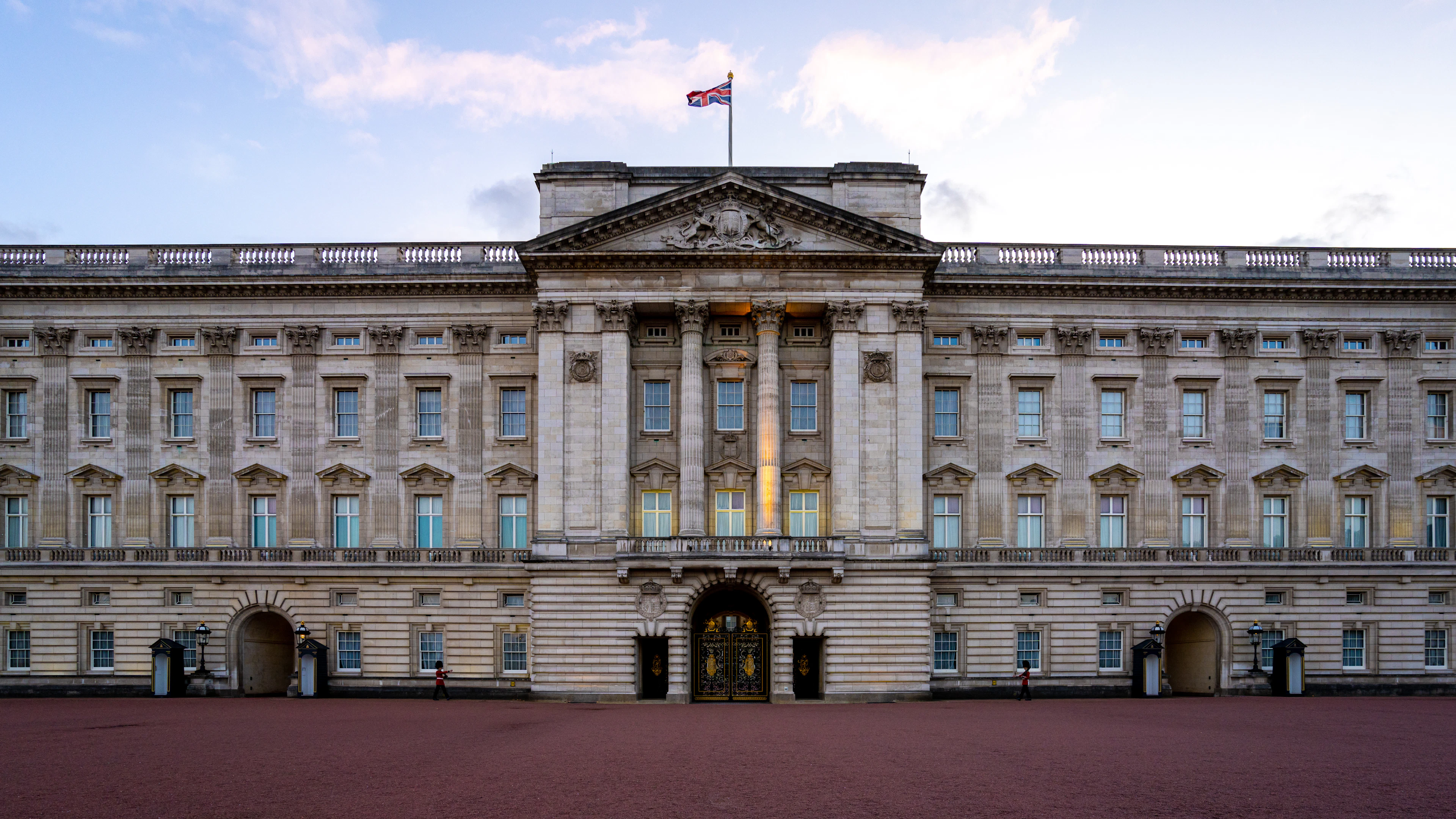 The front facade of Buckingham Palace in London, with the Royal Standard flying