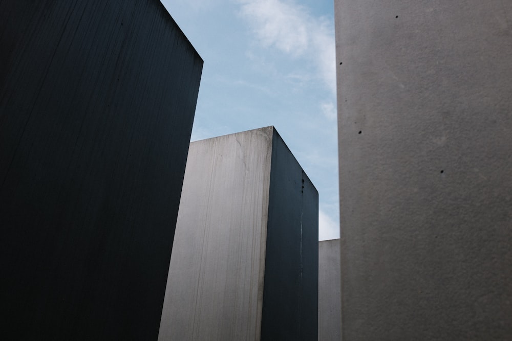 gray concrete walls under white clouds and blue sky