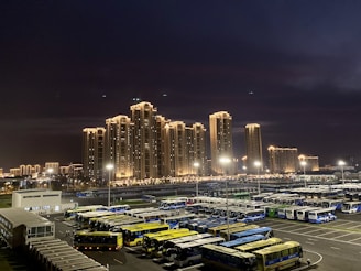A sleek NJ Sprinters bus parked in front of Newark city skyline at sunset.