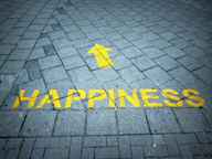a brick sidewalk with a yellow arrow painted on it