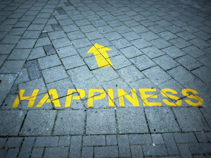 a brick sidewalk with a yellow arrow painted on it