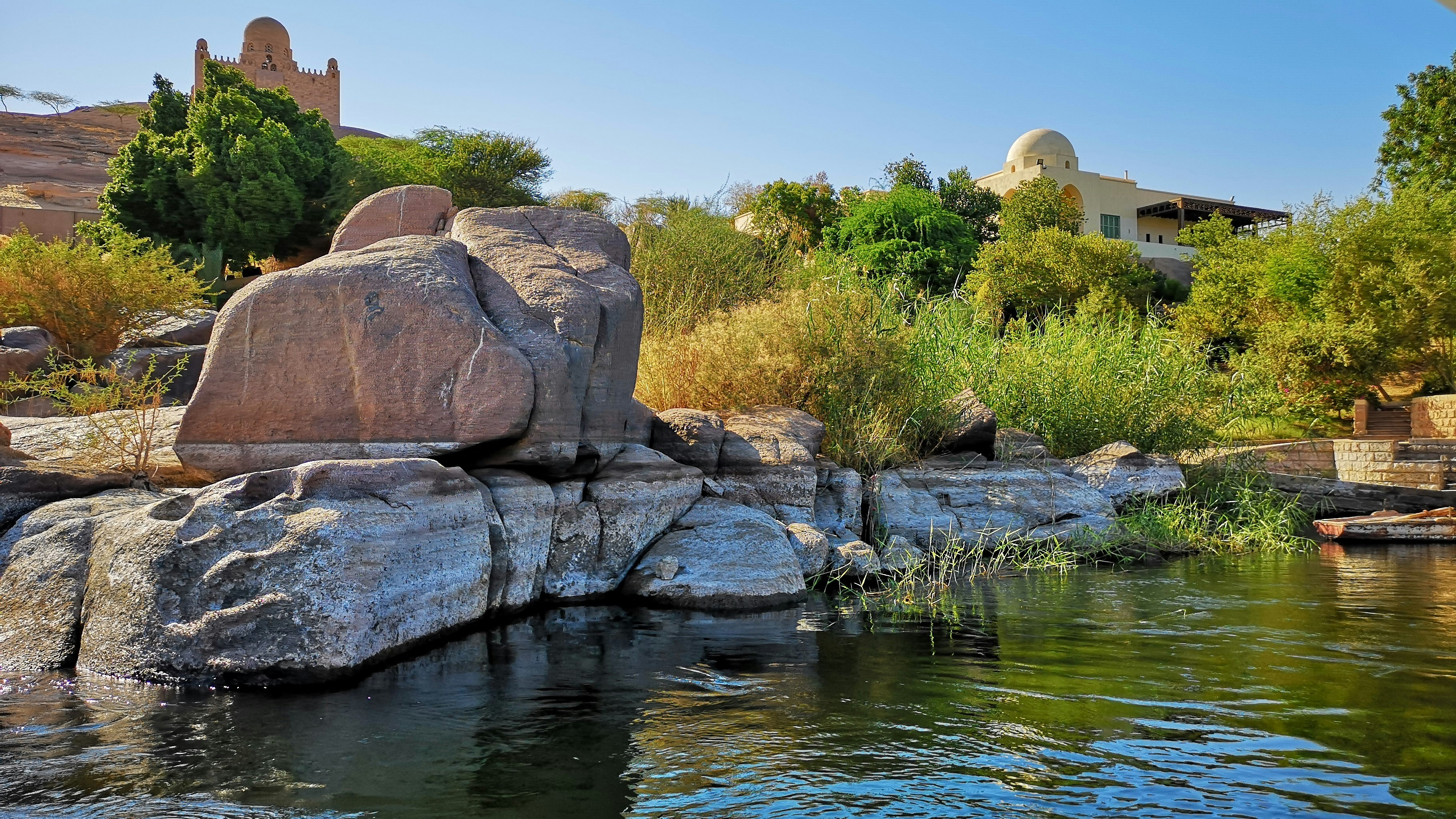 rock beside body of water