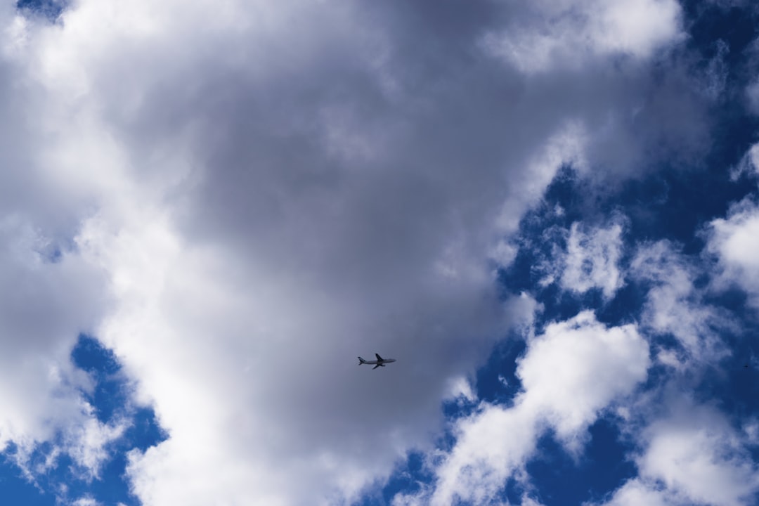 whtie airplane midair, the plane on the blue sky