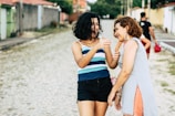 Father and daughter laughing together while walking along a city street.