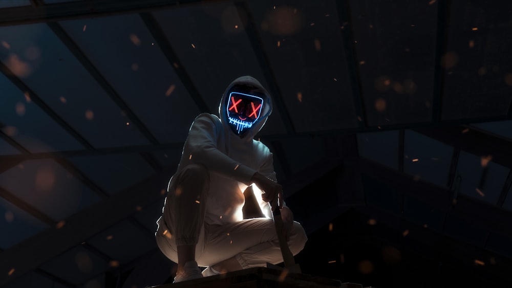 person white outfit wearing LED mask