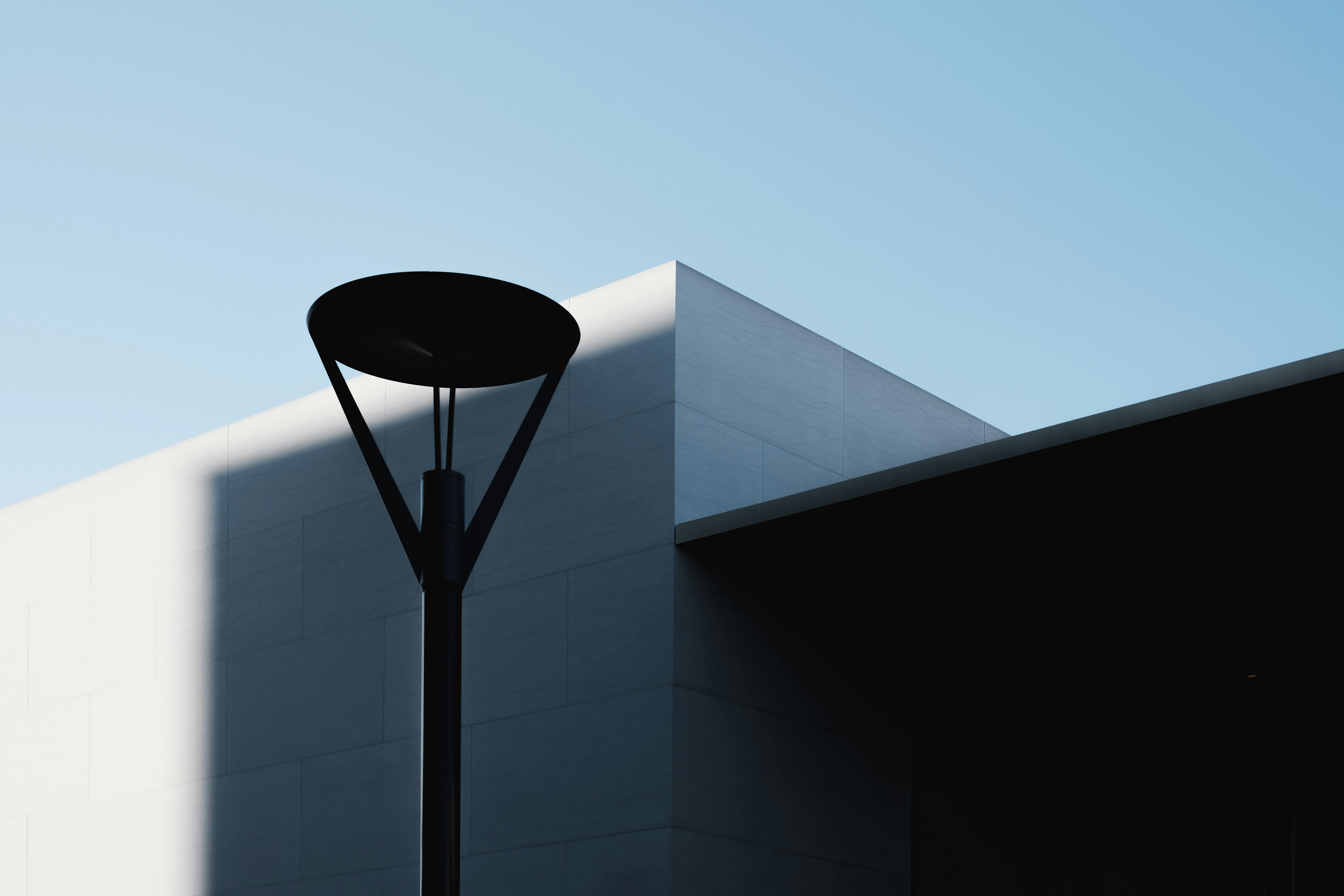 black post lamp beside white building