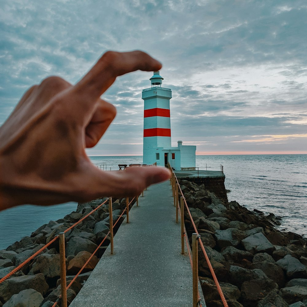 architectural photography of white and red lighthouse