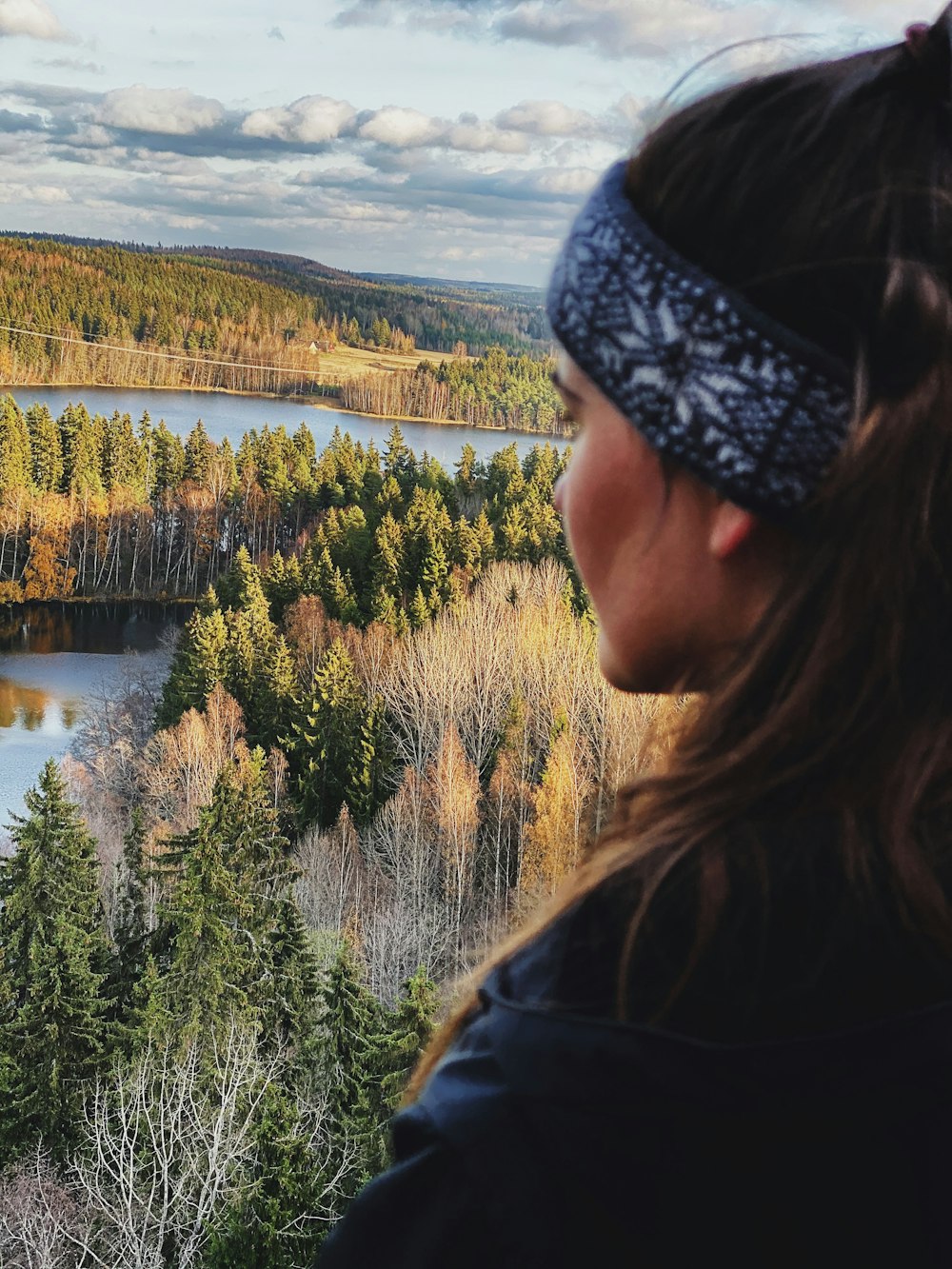 woman overlooking on river beside trees