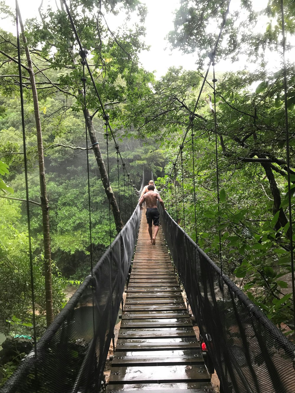 man passing through the bridge