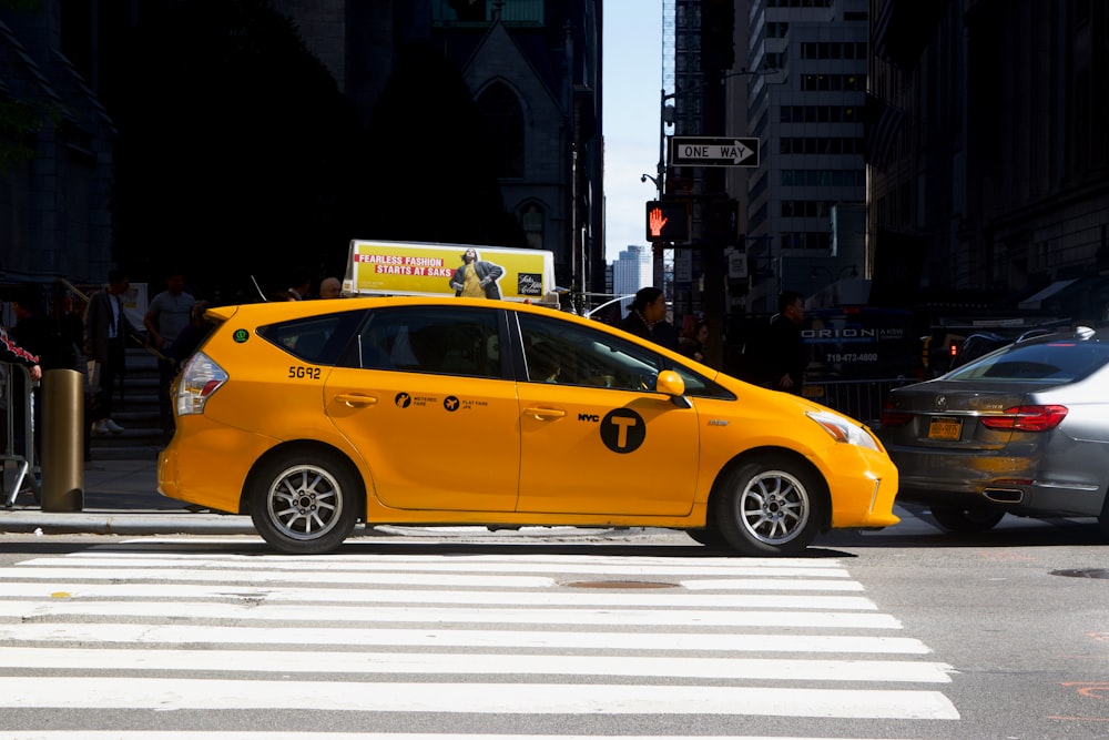 yellow car on road