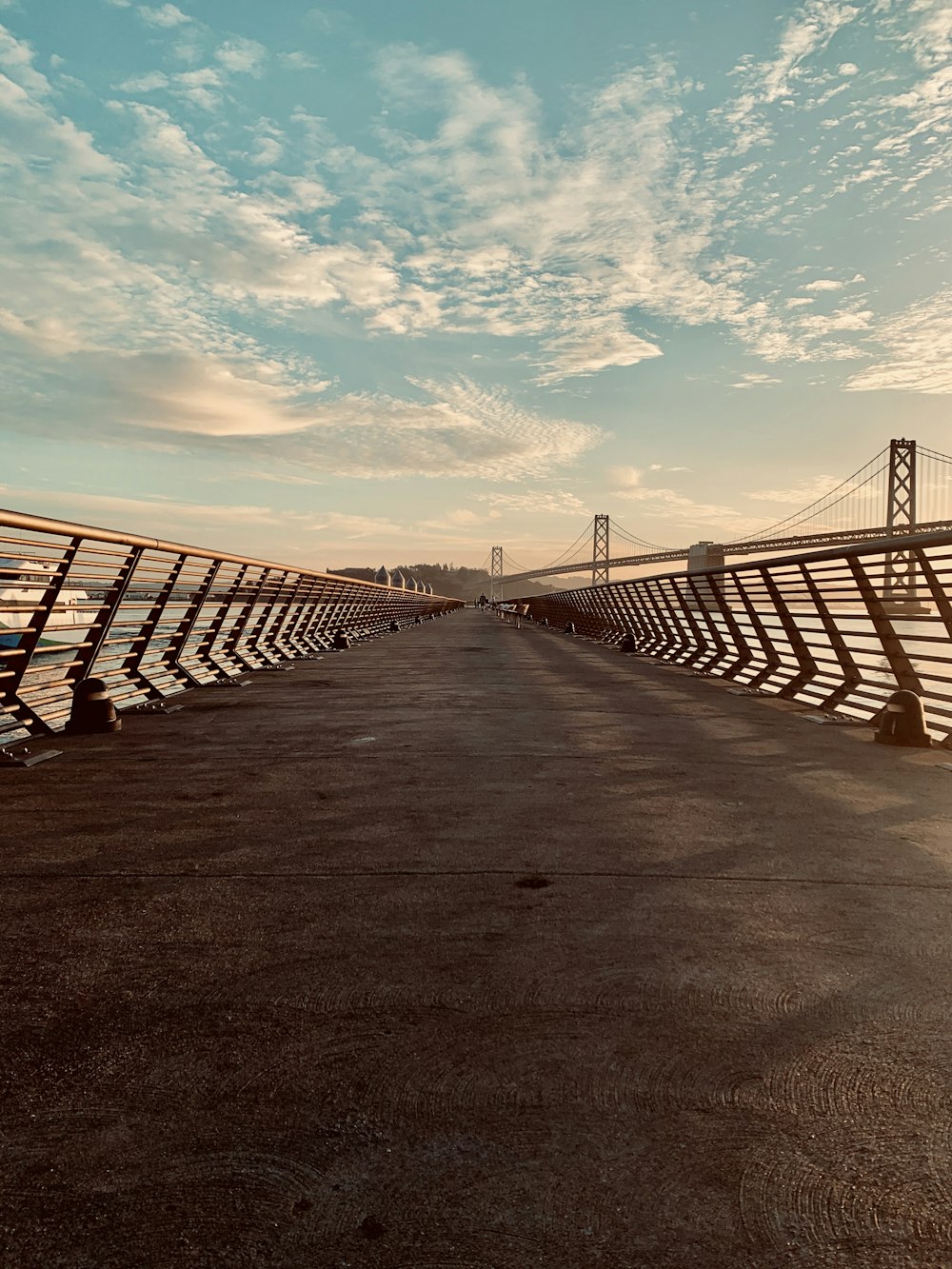 brown wooden bridge under blue sky during daytime