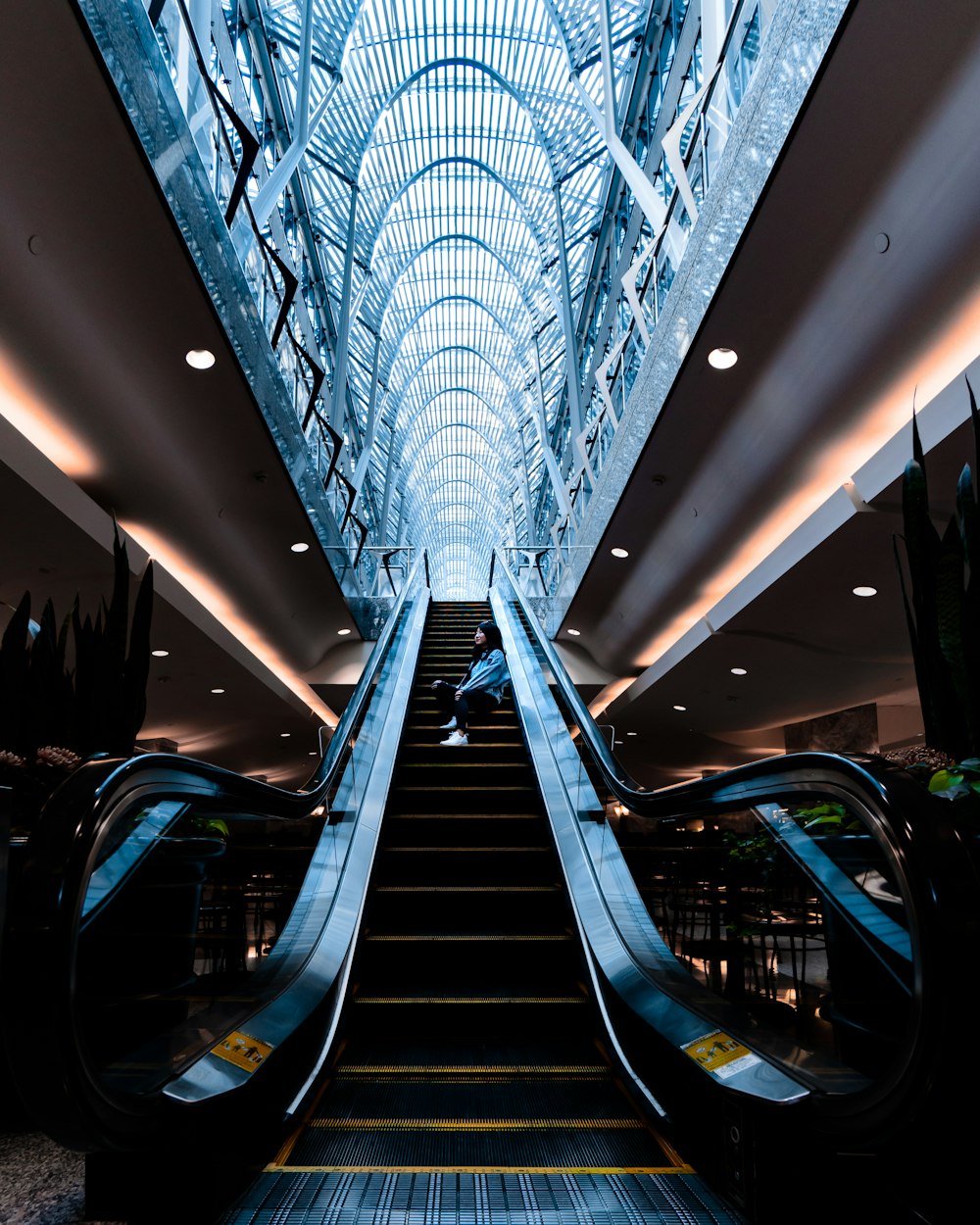 woman sitting on escalator